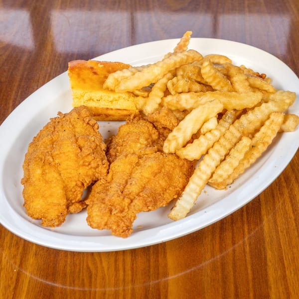 Melvin's at Riverside southern fried chicken tenders, crinkle-cut fries, and cornbread on a white plate.